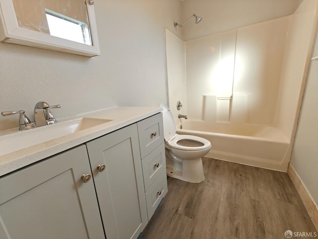 bathroom with toilet, bathtub / shower combination, wood finished floors, and vanity