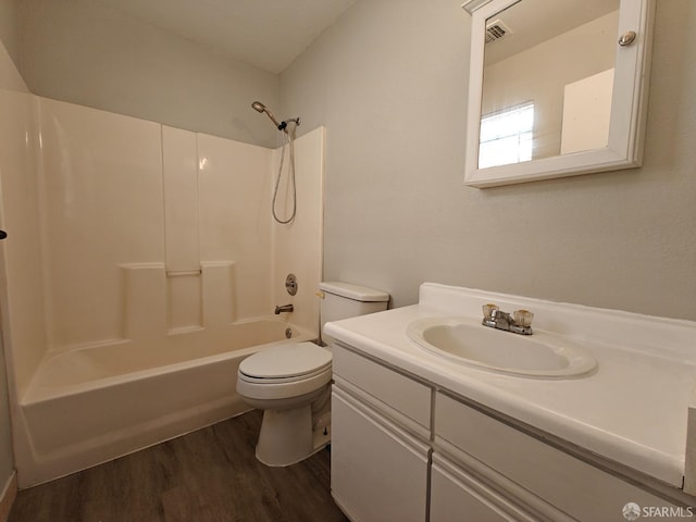 bathroom with shower / bathtub combination, visible vents, toilet, vanity, and wood finished floors