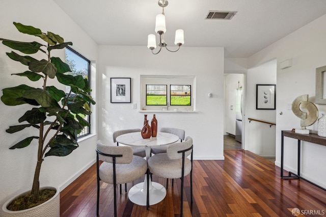 dining area featuring an inviting chandelier, dark hardwood / wood-style floors, and a wealth of natural light