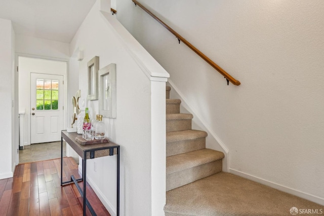 stairs featuring hardwood / wood-style flooring