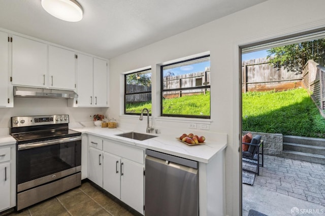 kitchen with white cabinetry, sink, a healthy amount of sunlight, and appliances with stainless steel finishes