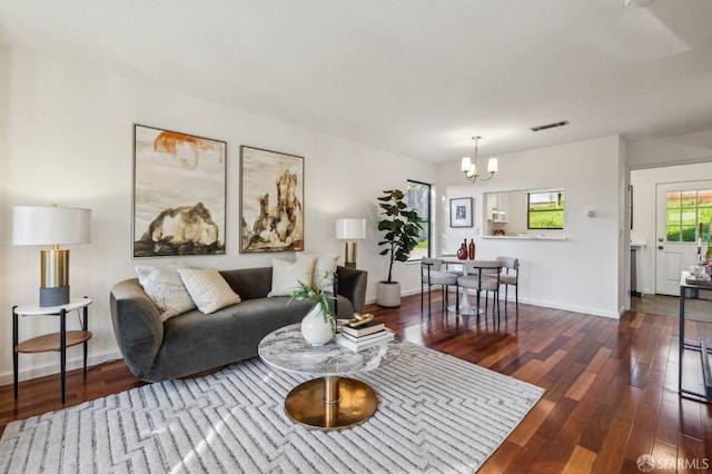 living room featuring dark hardwood / wood-style floors and a chandelier