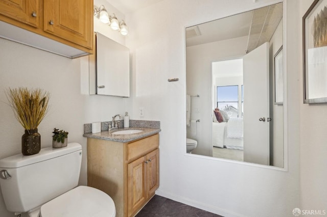 bathroom with vanity, tile patterned floors, and toilet