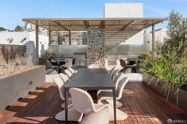 deck featuring an outdoor kitchen and area for grilling