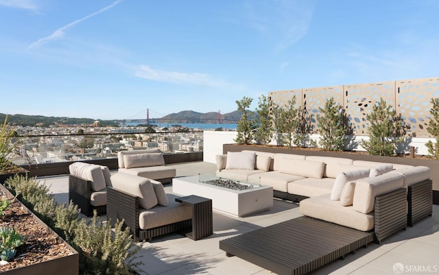 view of patio / terrace featuring a mountain view and an outdoor living space with a fire pit