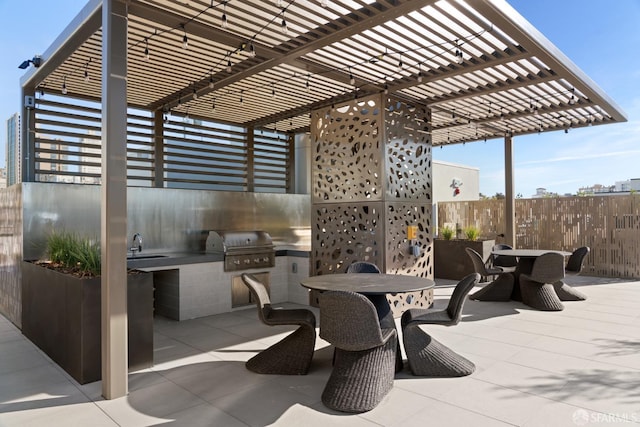 view of patio with exterior kitchen, sink, a grill, and a pergola