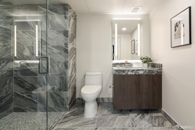 bathroom with vanity, toilet, and a shower with shower door