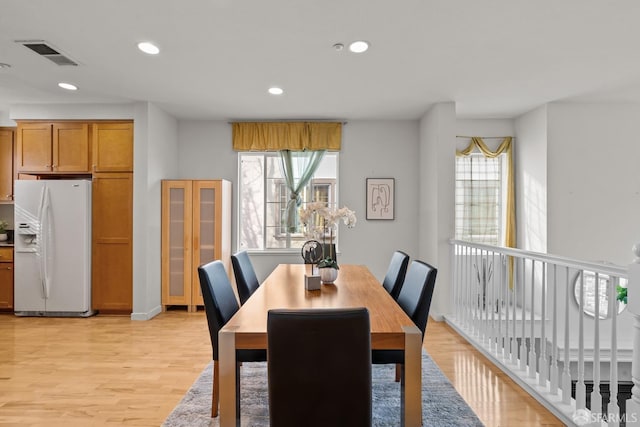 dining area featuring recessed lighting, a healthy amount of sunlight, visible vents, and light wood finished floors