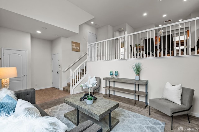 living area with stairs, recessed lighting, and baseboards