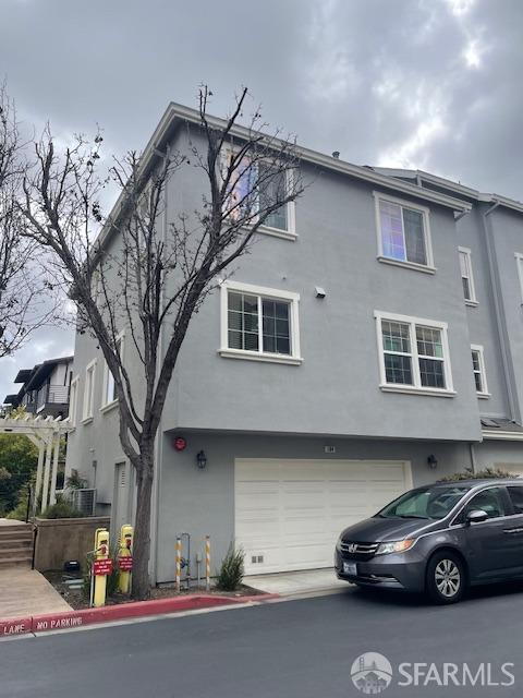 townhome / multi-family property with stucco siding and an attached garage