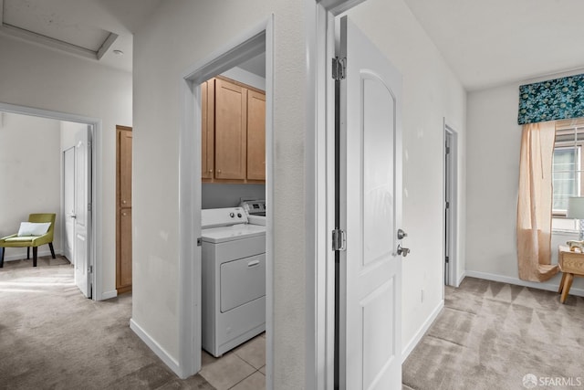 interior space featuring attic access, baseboards, independent washer and dryer, and light carpet