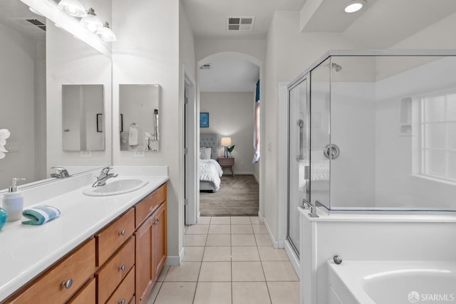 bathroom with visible vents, connected bathroom, a stall shower, tile patterned floors, and vanity