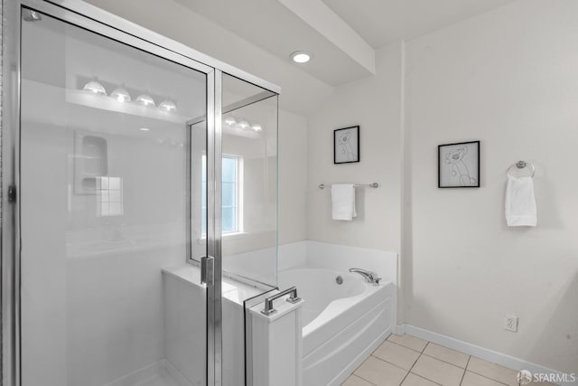 full bathroom with tile patterned floors, lofted ceiling, a stall shower, baseboards, and a bath