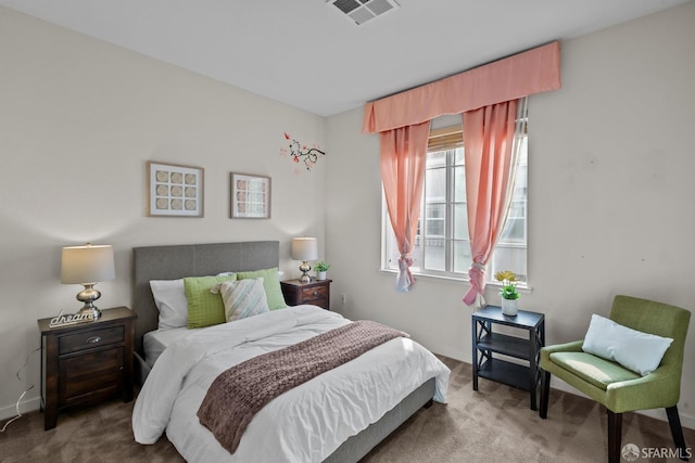 carpeted bedroom featuring visible vents and baseboards