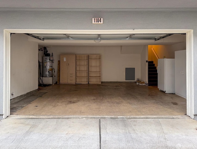 garage with secured water heater and freestanding refrigerator