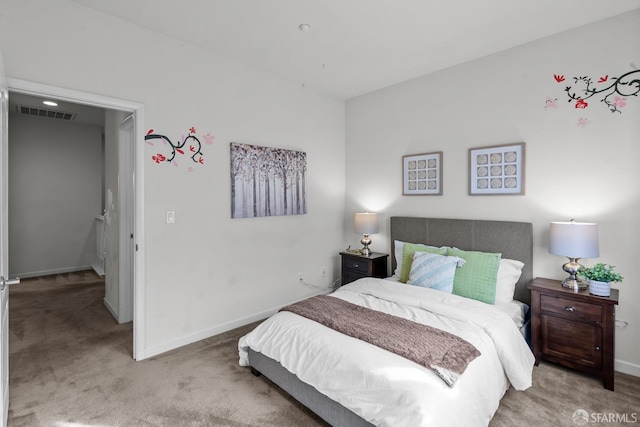 carpeted bedroom featuring visible vents and baseboards