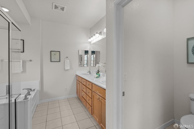 bathroom featuring visible vents, a garden tub, toilet, tile patterned flooring, and double vanity