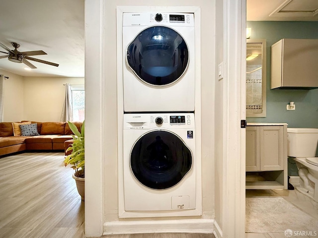 38002 Stenhammer Dr, Fremont, CA 94536 - laundry room with estacked washer and dryer, ceiling fan, and wood finished floors