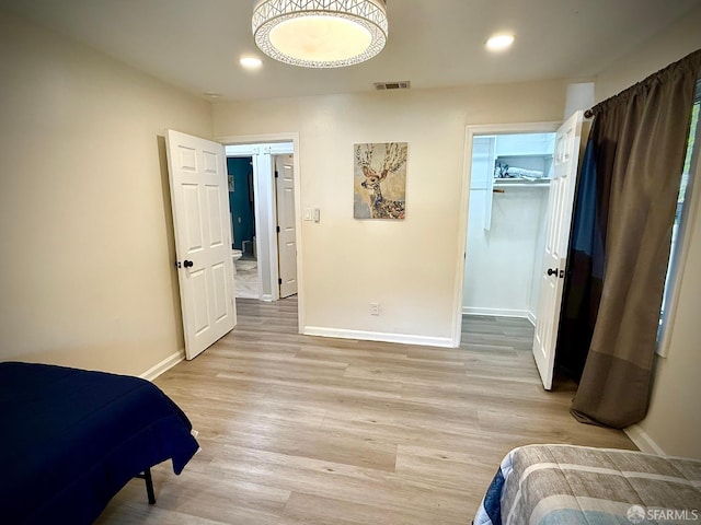 38002 Stenhammer Dr, Fremont, CA 94536 - bedroom featuring baseboards, light wood finished floors, recessed lighting, and a walk in closet