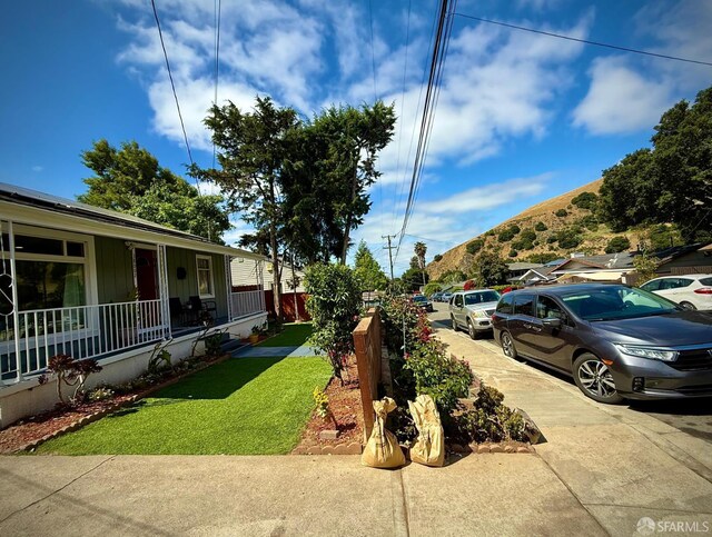 38002 Stenhammer Dr, Fremont, CA 94536 - view of green lawn with a mountain view and a porch