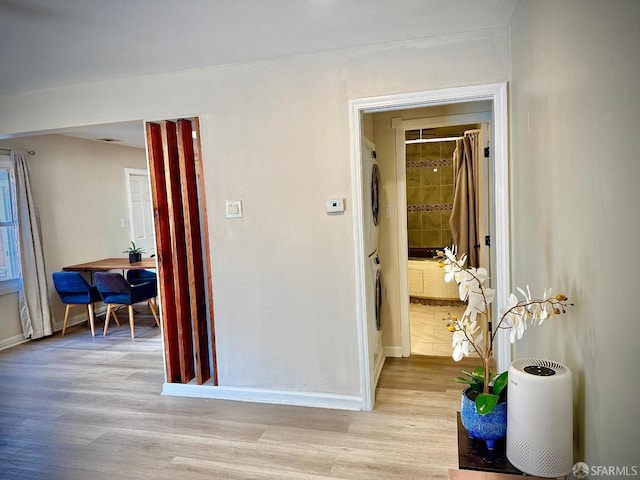38002 Stenhammer Dr, Fremont, CA 94536 - hall featuring estacked washer and dryer, light wood-style floors, and baseboards