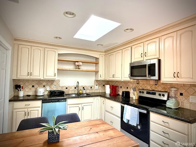 38002 Stenhammer Dr, Fremont, CA 94536 - kitchen featuring a sink, stainless steel appliances, a skylight, cream cabinets, and recessed lighting