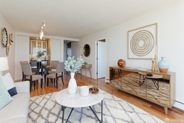 living room with wood-type flooring and a baseboard radiator