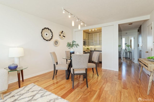 dining space featuring light wood-type flooring