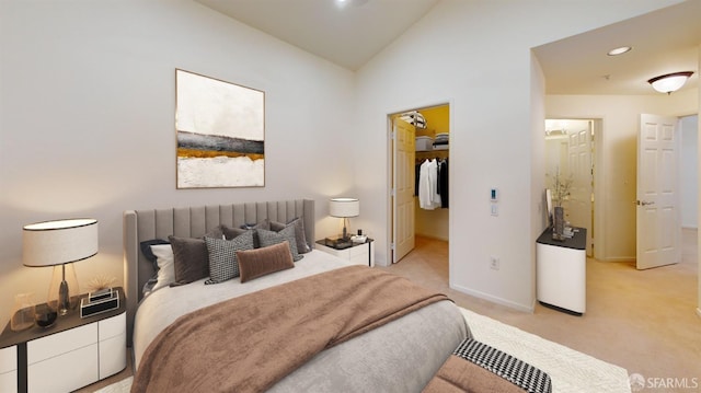 bedroom featuring lofted ceiling, a spacious closet, light colored carpet, and a closet