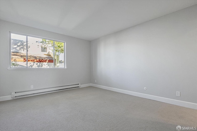 empty room with a baseboard heating unit and carpet flooring