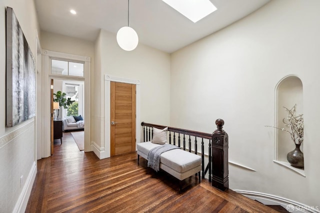 bedroom with dark hardwood / wood-style flooring and a skylight