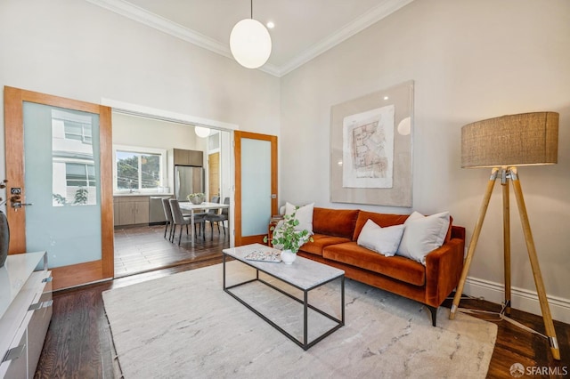 living room with ornamental molding and dark hardwood / wood-style floors