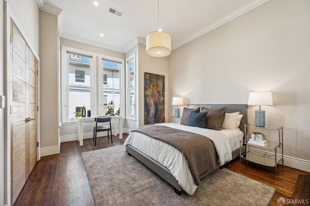 bedroom featuring ornamental molding and dark wood-type flooring