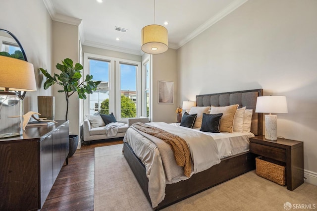 bedroom with crown molding and hardwood / wood-style floors