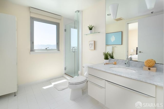 bathroom featuring vanity, toilet, and a shower with shower door