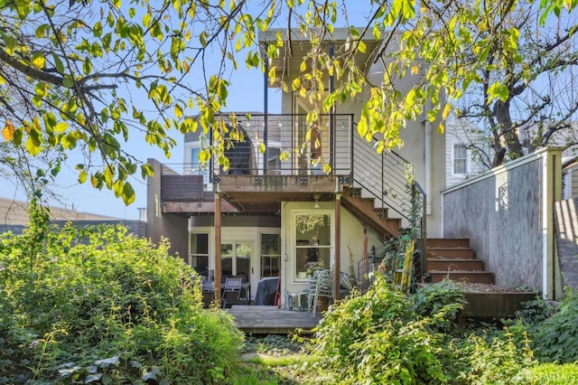 rear view of house featuring a deck