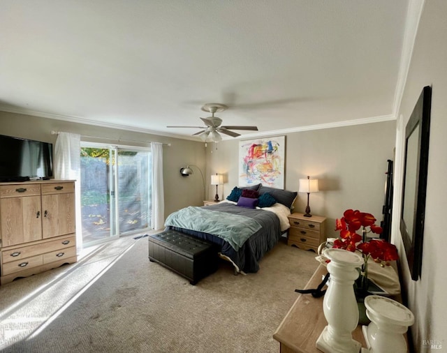 carpeted bedroom with ornamental molding and ceiling fan