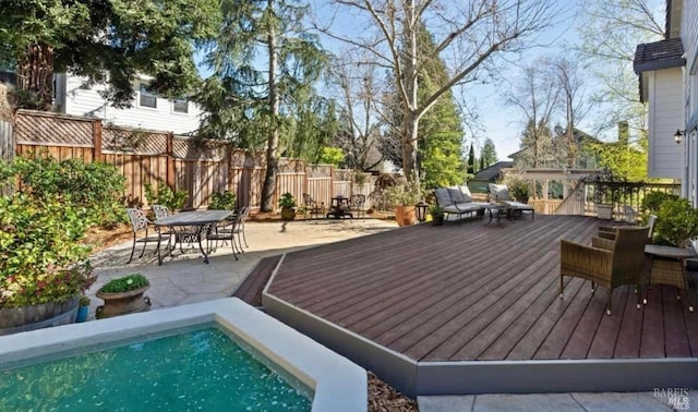 wooden deck featuring a fenced in pool