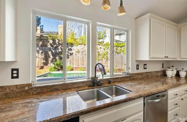 kitchen featuring white cabinetry, pendant lighting, dishwasher, and sink