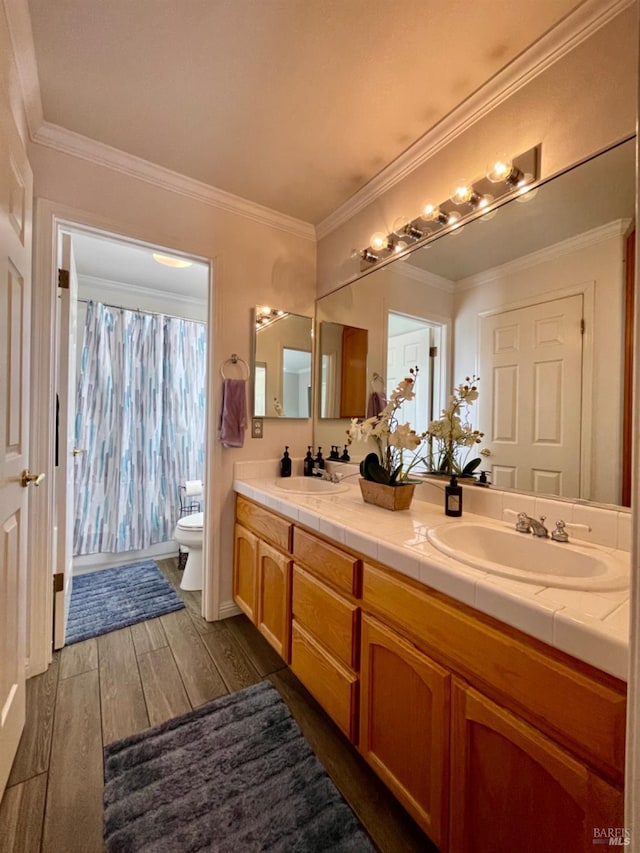 bathroom with vanity, ornamental molding, hardwood / wood-style floors, and toilet