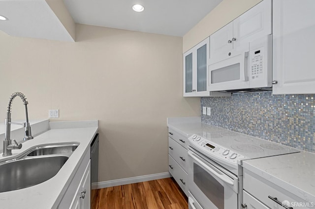 875 La Playa St Unit 373, San Francisco, CA 94121 - kitchen with white appliances, a sink, wood finished floors, tasteful backsplash, and baseboards