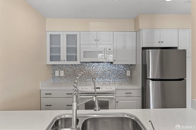 875 La Playa St Unit 373, San Francisco, CA 94121 - kitchen featuring white appliances, decorative backsplash, white cabinetry, and glass insert cabinets