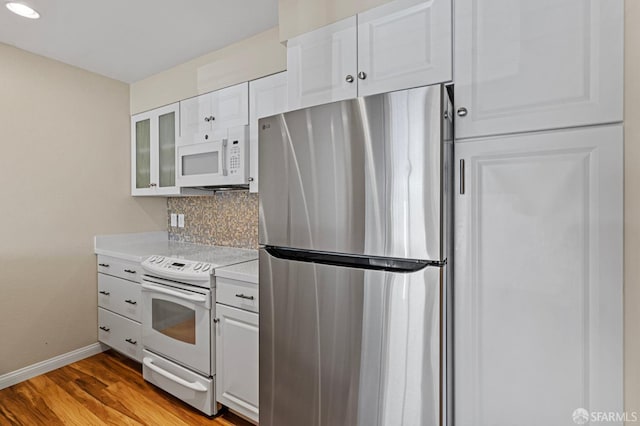 875 La Playa St Unit 373, San Francisco, CA 94121 - kitchen featuring white appliances, backsplash, light countertops, baseboards, and white cabinetry