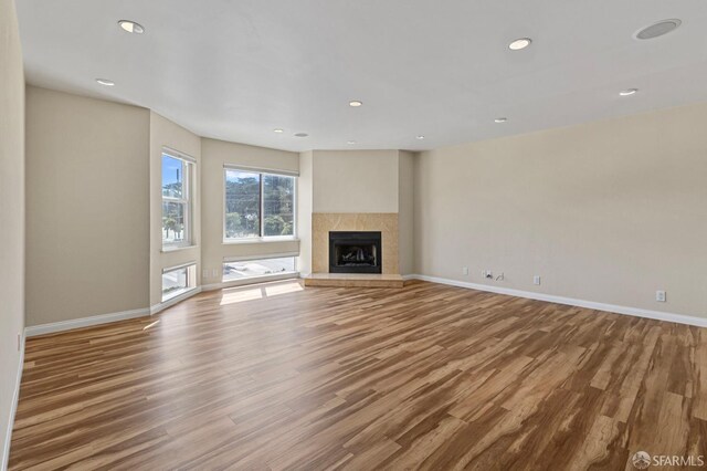 875 La Playa St Unit 373, San Francisco, CA 94121 - unfurnished living room featuring wood finished floors, baseboards, a tile fireplace, and recessed lighting