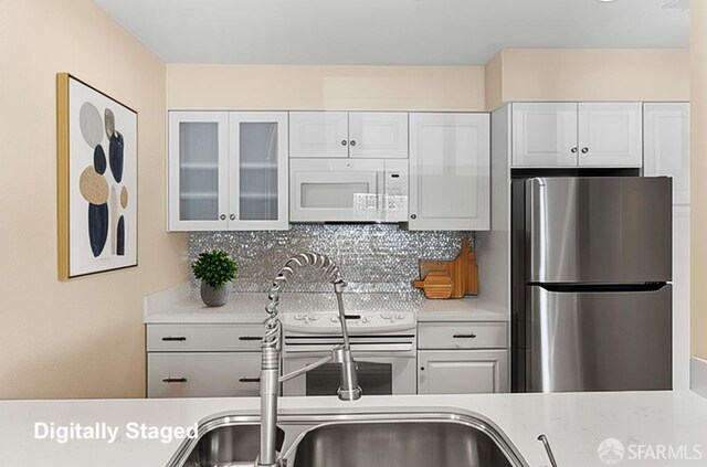875 La Playa St Unit 373, San Francisco, CA 94121 - kitchen featuring white appliances, light countertops, decorative backsplash, and glass insert cabinets