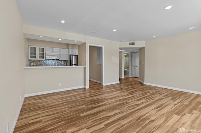 875 La Playa St Unit 373, San Francisco, CA 94121 - unfurnished living room featuring light wood-style flooring, recessed lighting, and baseboards