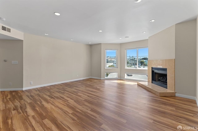 875 La Playa St Unit 373, San Francisco, CA 94121 - unfurnished living room with wood finished floors, baseboards, a fireplace with raised hearth, and recessed lighting