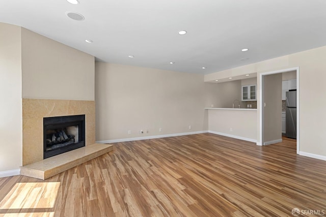 875 La Playa St Unit 373, San Francisco, CA 94121 - unfurnished living room with wood finished floors, a high end fireplace, baseboards, recessed lighting, and a sink