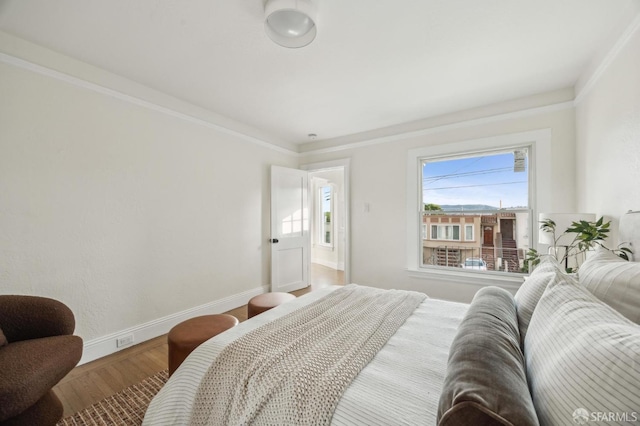 bedroom featuring hardwood / wood-style flooring and ornamental molding