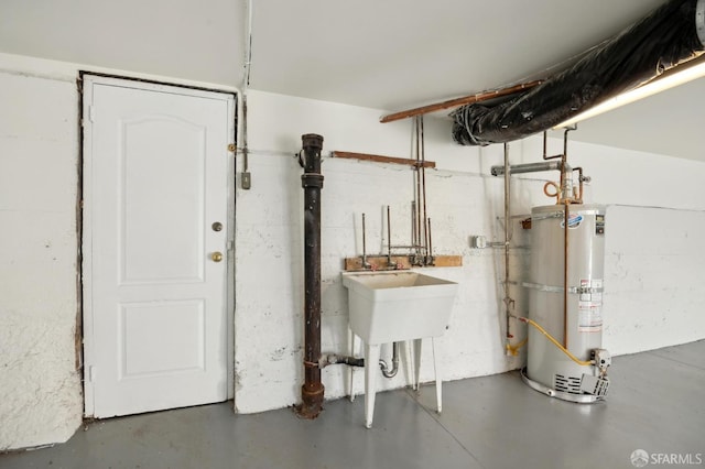 utility room with sink and water heater